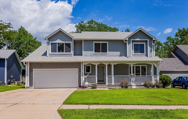 3015 Deerpath Ct, Des Moines, IA 50320 - view of front of house with covered porch, a front yard, concrete driveway, a garage, and roof with shingles