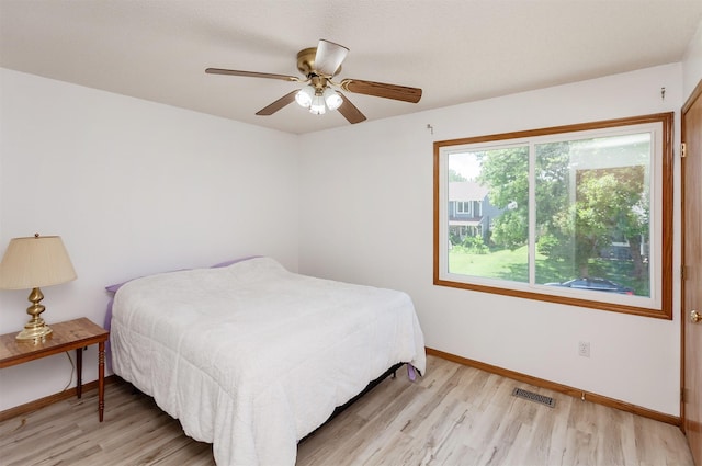 3015 Deerpath Ct, Des Moines, IA 50320 - bedroom with light wood finished floors and ceiling fan