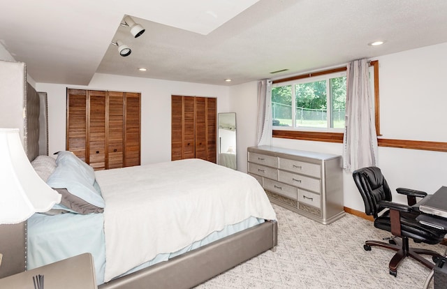 3015 Deerpath Ct, Des Moines, IA 50320 - bedroom featuring two closets, light colored carpet, recessed lighting, and a desk