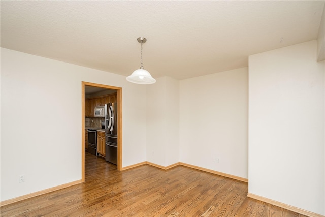 unfurnished room featuring hardwood / wood-style flooring