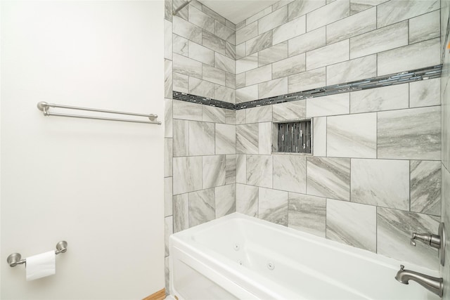 bathroom featuring tiled shower / bath