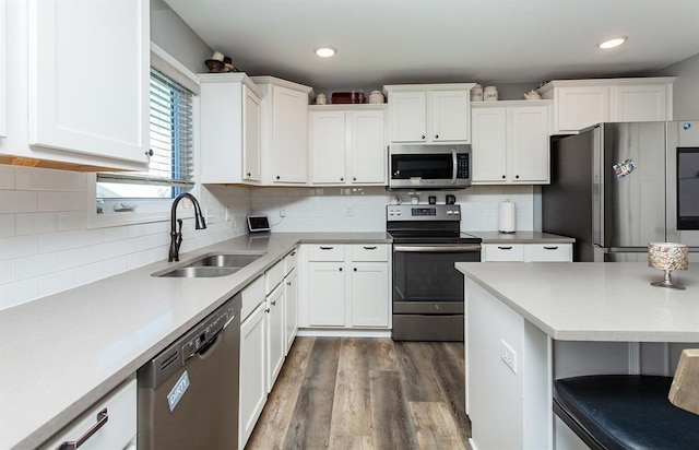 kitchen featuring white cabinetry, appliances with stainless steel finishes, dark hardwood / wood-style flooring, and sink