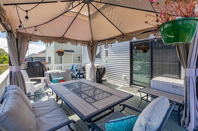 wooden terrace with a gazebo and grilling area