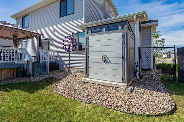 rear view of property with a yard and a storage shed