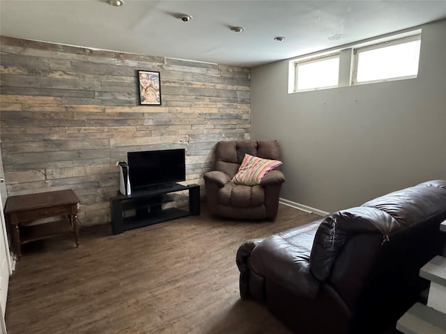 living room with wood-type flooring and wooden walls