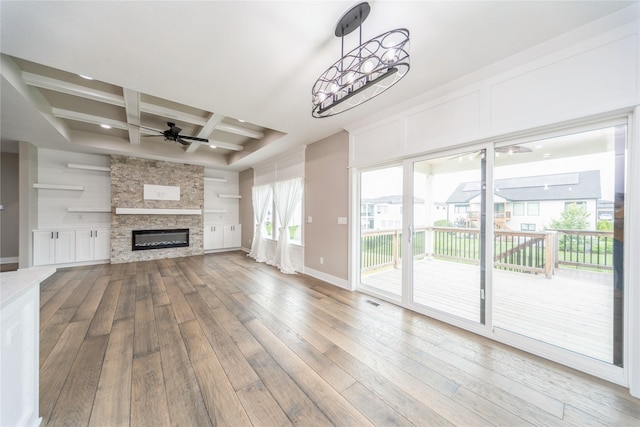 2938 NE Brentwood Cir, Grimes, IA 50111 - unfurnished living room featuring ceiling fan, hardwood / wood-style floors, coffered ceiling, beam ceiling, and healthy amount of natural light