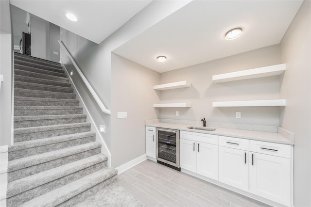 2938 NE Brentwood Cir, Grimes, IA 50111 - indoor wet bar with beverage cooler, stairway, and light wood-style flooring