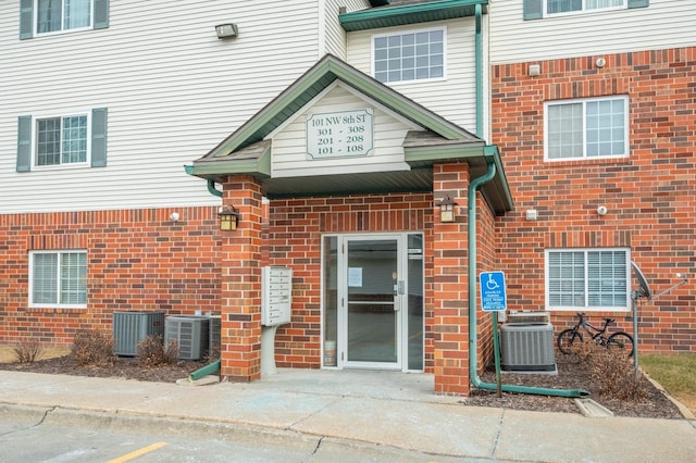 doorway to property featuring central AC unit