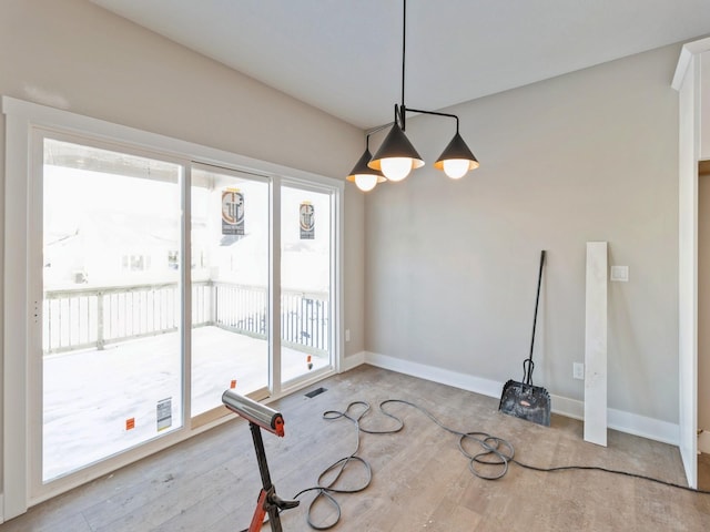 unfurnished dining area featuring light hardwood / wood-style flooring