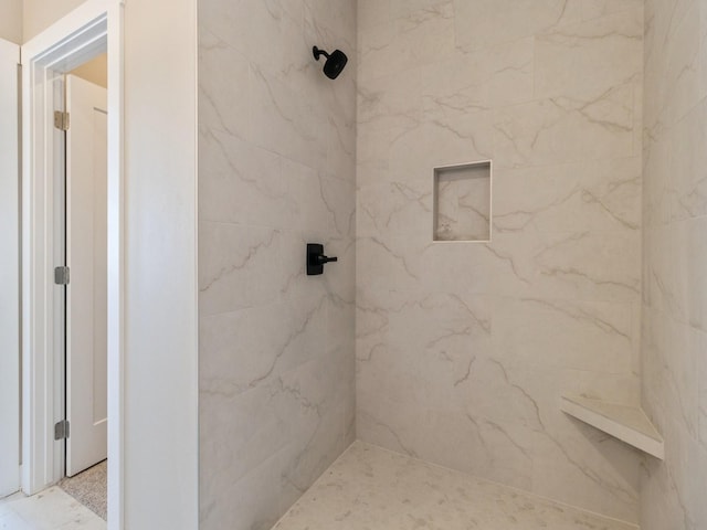 bathroom with tiled shower