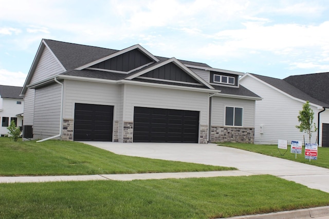 4651 180th St, Urbandale, IA 50323 - craftsman-style home featuring board and batten siding, stone siding, concrete driveway, and a front yard