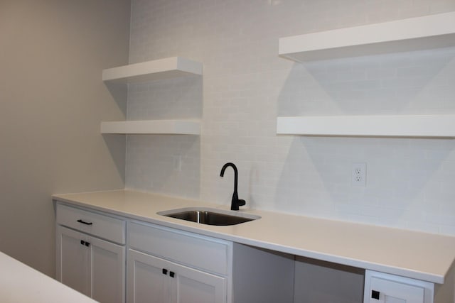 4651 180th St, Urbandale, IA 50323 - kitchen featuring open shelves, tasteful backsplash, light countertops, and white cabinets
