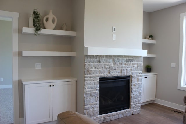 4651 180th St, Urbandale, IA 50323 - living room featuring a stone fireplace and wood finished floors