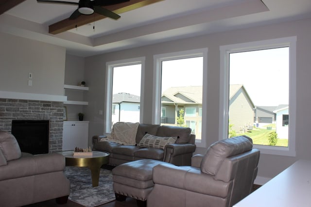 4651 180th St, Urbandale, IA 50323 - living area featuring a ceiling fan, a tray ceiling, beamed ceiling, and a fireplace