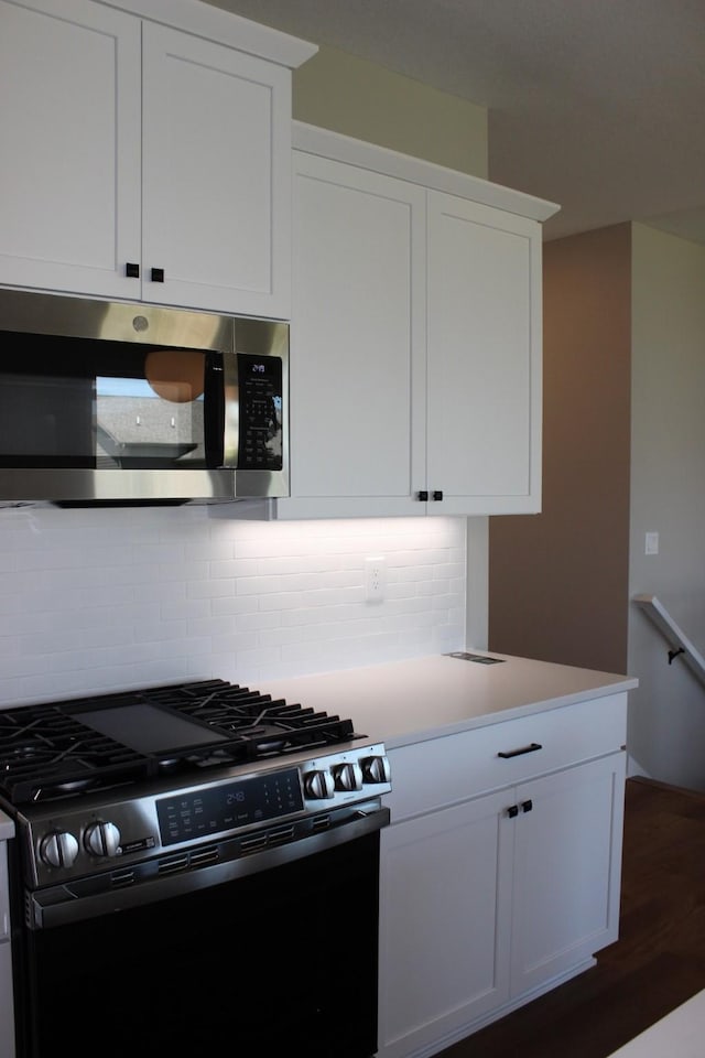 4651 180th St, Urbandale, IA 50323 - kitchen with stainless steel appliances, backsplash, and white cabinetry