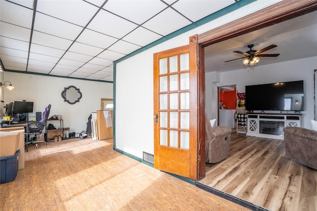 living room with hardwood / wood-style floors, washer / dryer, a paneled ceiling, and ceiling fan