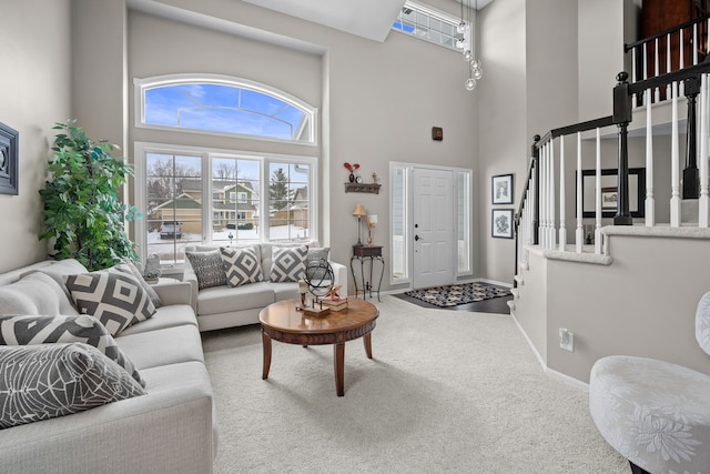 living room featuring carpet and a towering ceiling