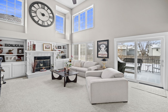 living room featuring a fireplace and light colored carpet