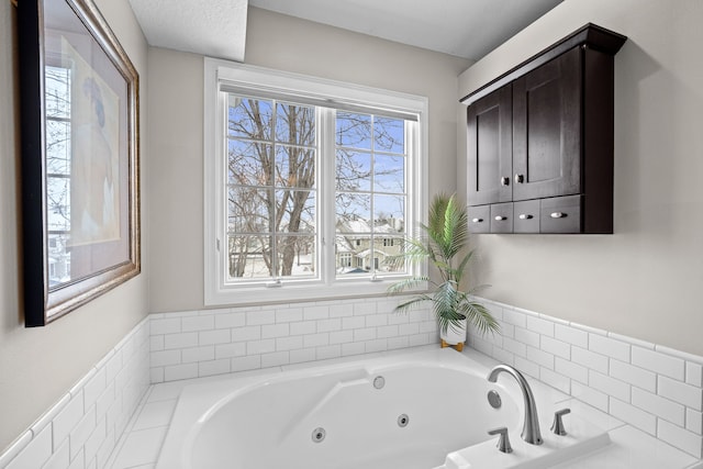 bathroom with a relaxing tiled tub and a wealth of natural light