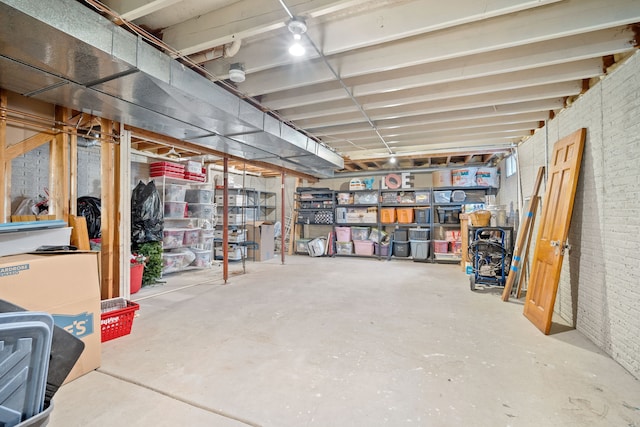 basement featuring brick wall