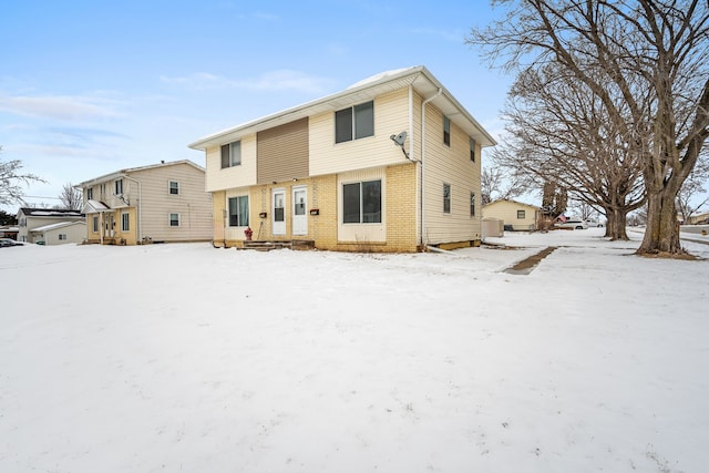 view of snow covered rear of property