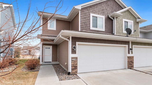 townhome / multi-family property featuring stone siding, concrete driveway, and an attached garage