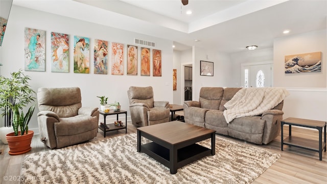 living area with recessed lighting, visible vents, and light wood finished floors