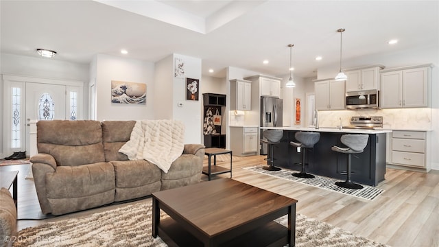 living room with recessed lighting and light wood-style floors