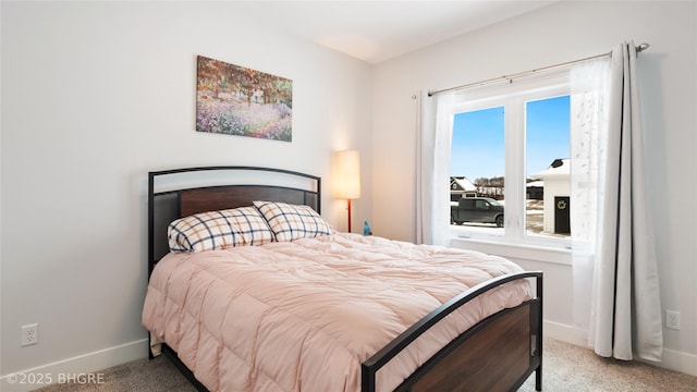 bedroom with light carpet and baseboards