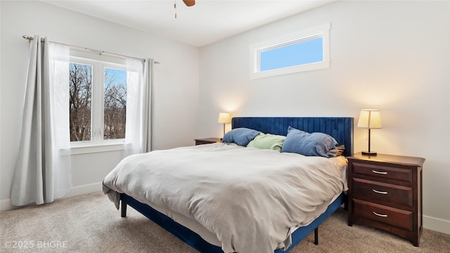 bedroom featuring light carpet, baseboards, and a ceiling fan