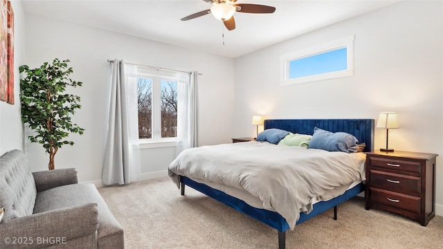 bedroom featuring ceiling fan, multiple windows, baseboards, and light colored carpet