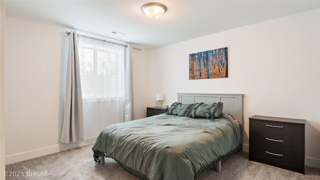 bedroom with light carpet and baseboards