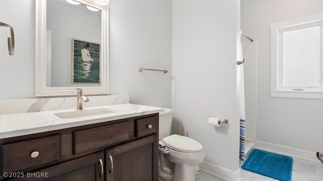 bathroom with marble finish floor, toilet, vanity, and baseboards