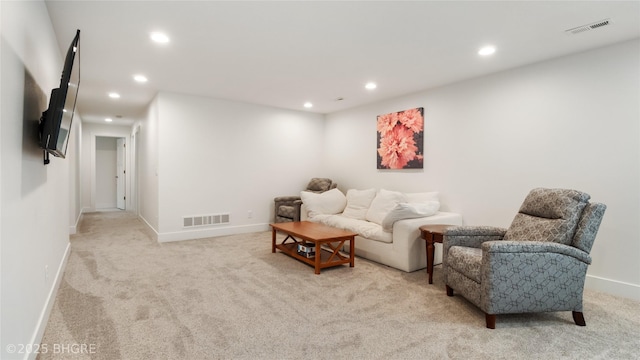 living room featuring recessed lighting, visible vents, baseboards, and light colored carpet