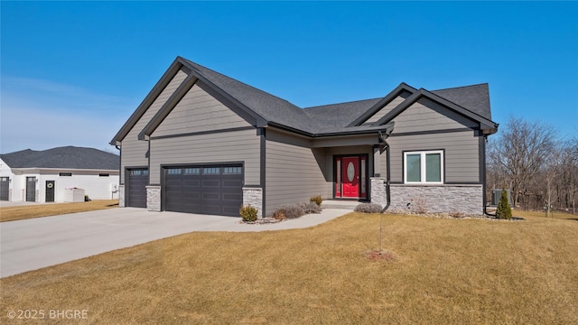 craftsman-style house featuring stone siding, a front lawn, and concrete driveway