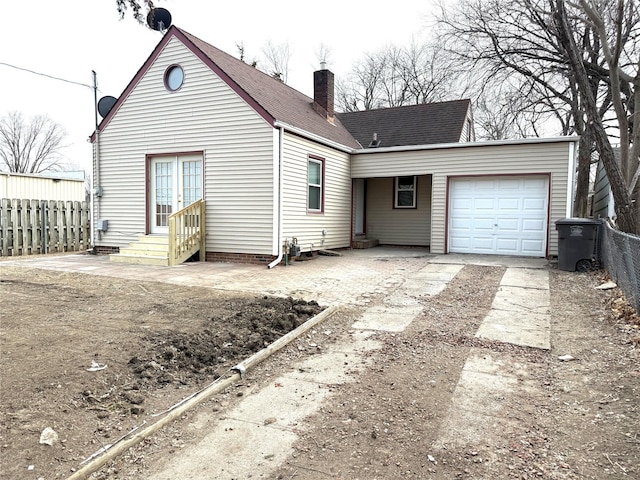 rear view of property with a garage