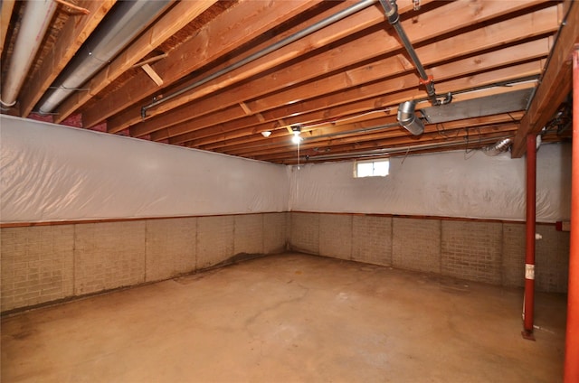 basement featuring brick wall