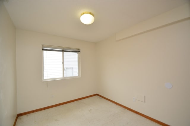 unfurnished room featuring baseboards and tile patterned floors