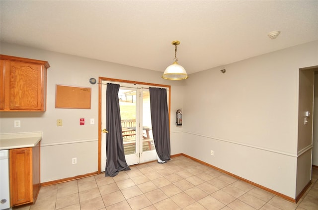 unfurnished dining area with baseboards