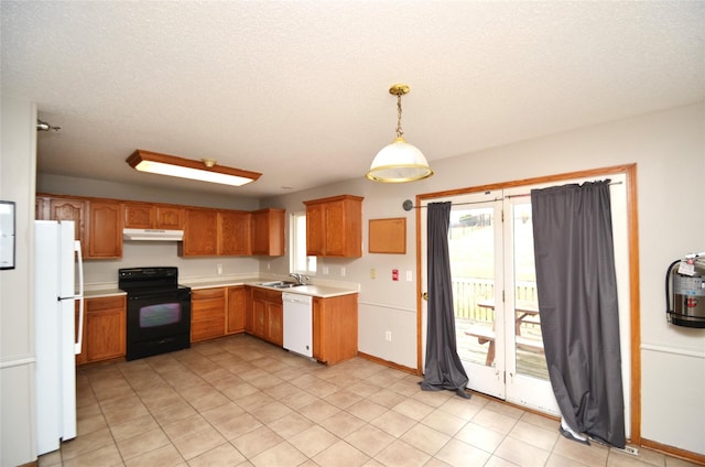 kitchen with pendant lighting, light countertops, a sink, white appliances, and under cabinet range hood