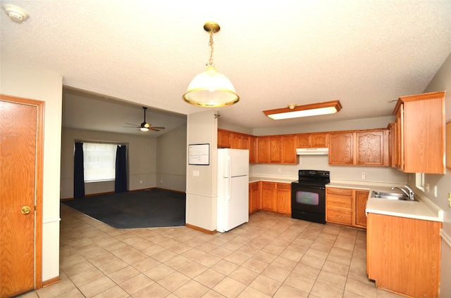 kitchen with black electric range oven, decorative light fixtures, freestanding refrigerator, light countertops, and under cabinet range hood