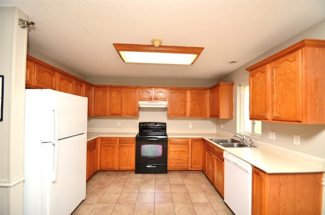 kitchen with under cabinet range hood, white appliances, a sink, light countertops, and brown cabinets