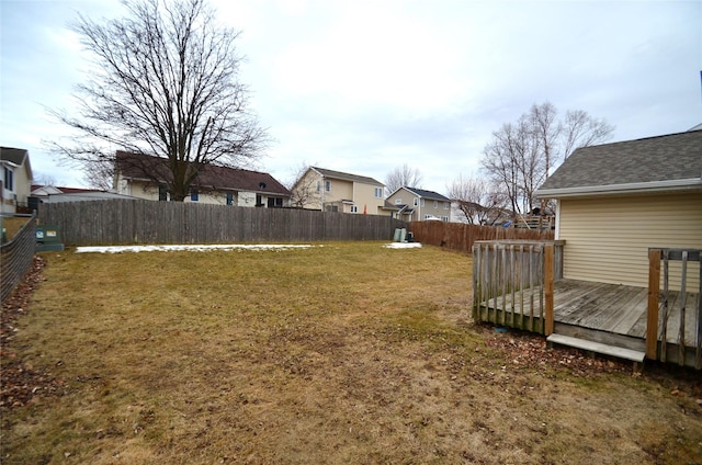 view of yard with a fenced backyard, a residential view, and a wooden deck