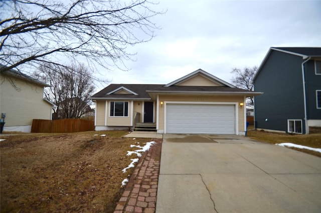 ranch-style house with a garage, concrete driveway, and fence