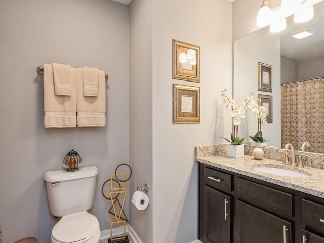 bathroom featuring toilet and vanity