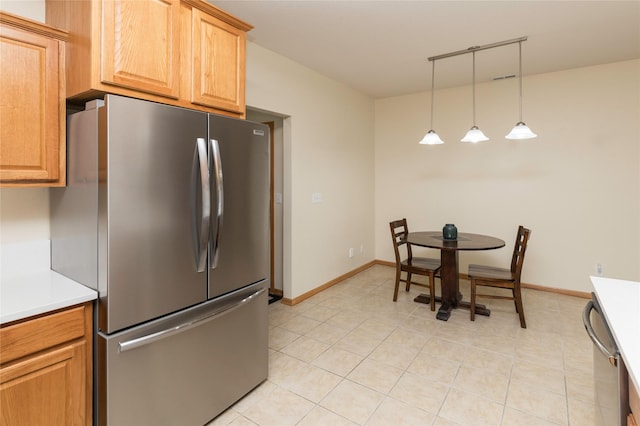 kitchen with appliances with stainless steel finishes, decorative light fixtures, and light tile patterned floors