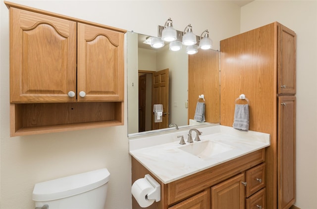 bathroom featuring toilet and vanity