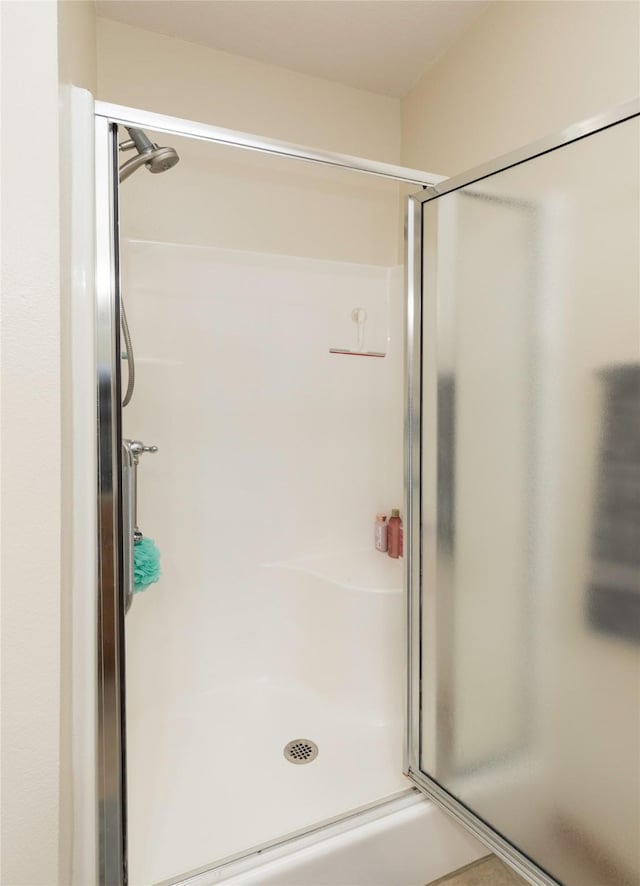 bathroom with a shower with door