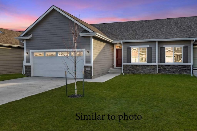 single story home featuring driveway, stone siding, and an attached garage