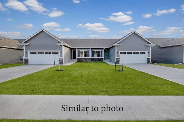 single story home with an attached garage, stone siding, a front lawn, and concrete driveway